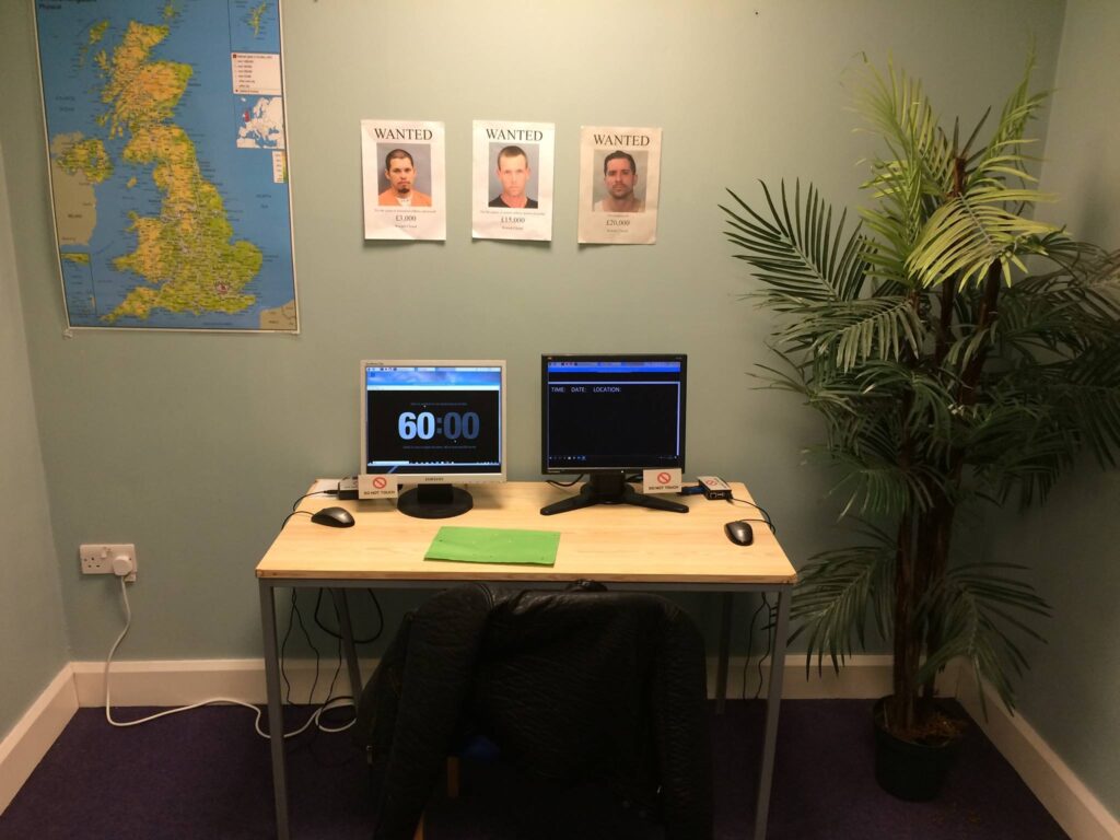 An empty escape room with "Wanted" pictures and a UK map on the wall